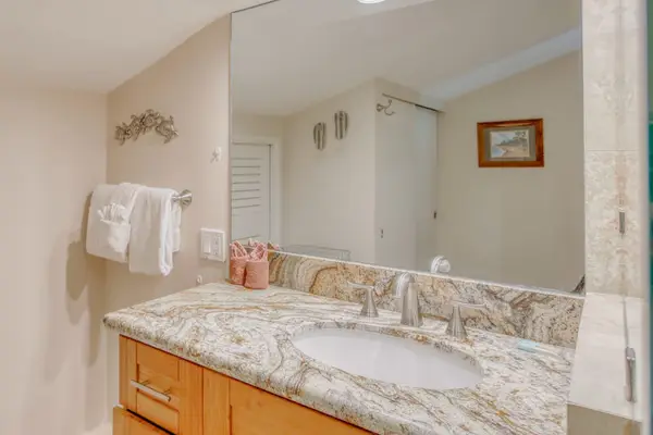 Master bathroom with tiled wall in shower.
