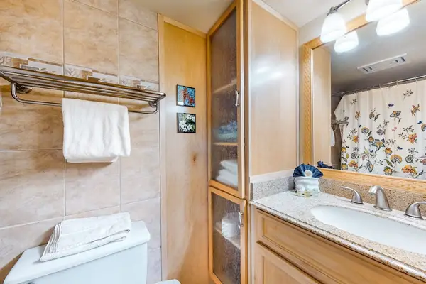 Full bathroom with shower and convenient storage