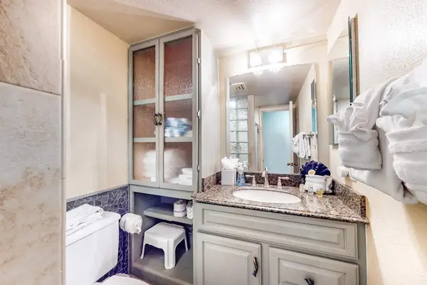 Guest bathroom equipped with modern vanity and walk-in shower