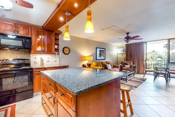Spacious kitchen with island seating and warm wood cabinetry