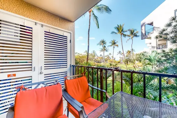 Breezy balcony with colorful seating and tropical views