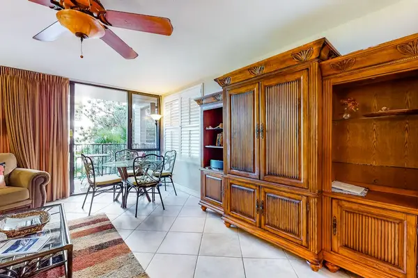 Open living space with entertainment center and balcony access
