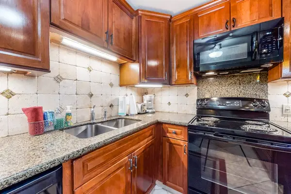 Well-equipped kitchen with rich wood cabinetry