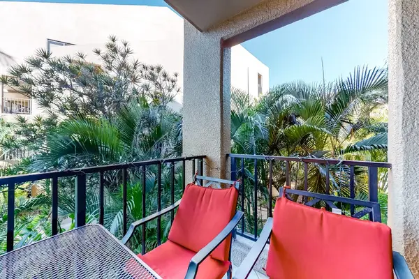 Tropical balcony with colorful seating and garden views