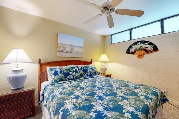 Serene Bedroom Suite with Tropical Bedding & Ceiling Fan