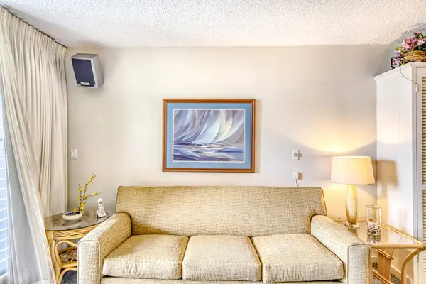 Living room leading to the lanai with a sofa bed for extra company.