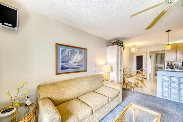 Living room leading to the lanai with a sofa bed for extra company.