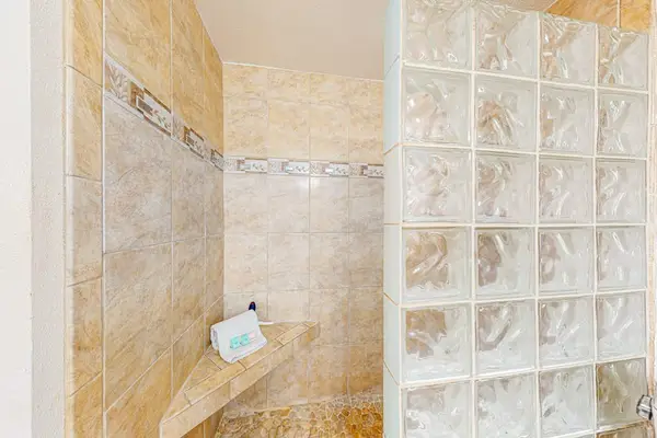 Refreshing walk-in shower with glass-block detailing