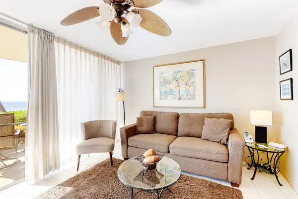Light filled living room with fan to keep you cool and a flatscreen tv and a sofa bed for extra company.