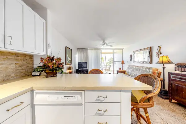 Updated open air kitchen with barstools for extra seating or for your sous chef.