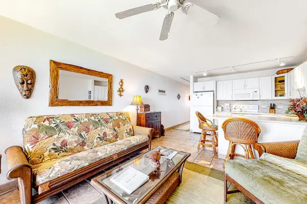Bright living room with sliding glass doors, abundant natural light and flatscreen tv.