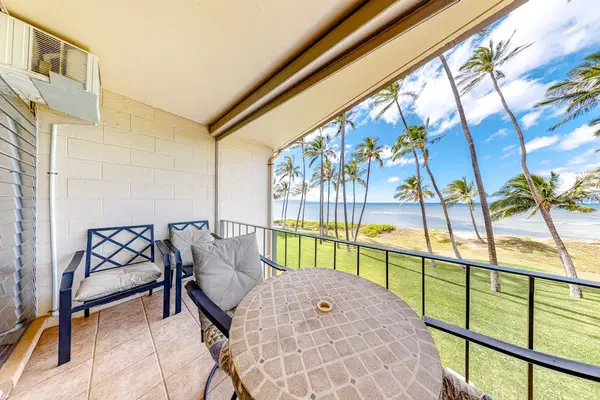 Private lanai with tropical views of palm trees swaying in the breeze.