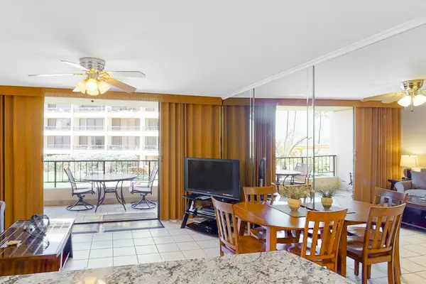 Living room with flat screen tv and lots of natural streaming in from the lanai.