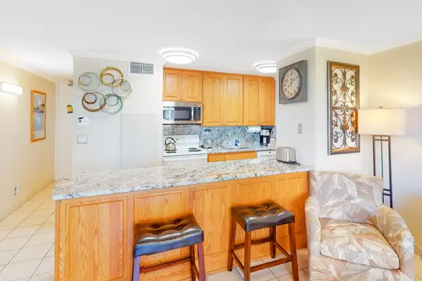 Two barstools at the kitchen counter for extra seating.