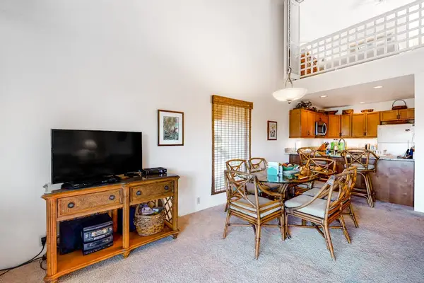 Open living room connects dining kitchen television for relaxing stays
