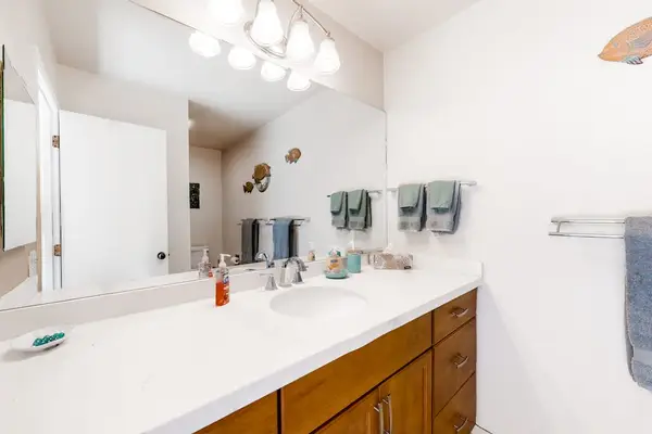 Full bathroom vanity offers wide counter space mirrors and lighting