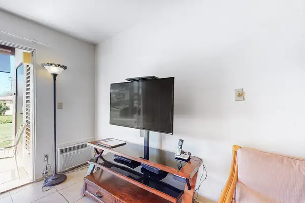 Relaxing living space with flat-screen TV and cozy lighting