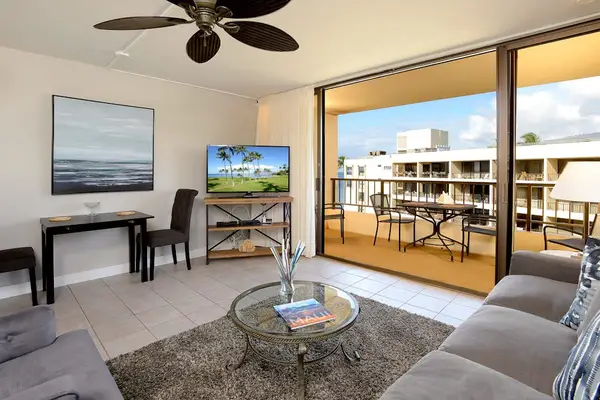 Modern new living room with comfortable furniture and flatscreen TV.