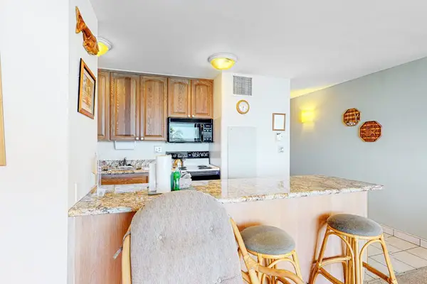 Kitchen counter with barstools for extra seating.