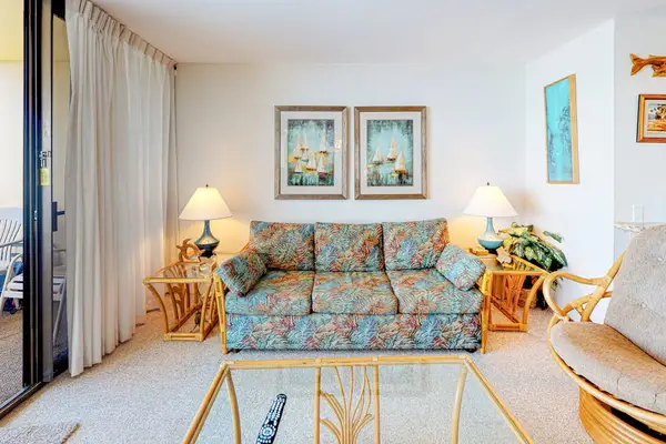 Open living room with lots of natural light and a sofa bed for extra company.