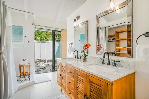 Master bathroom with double sinks and large walk-in shower.