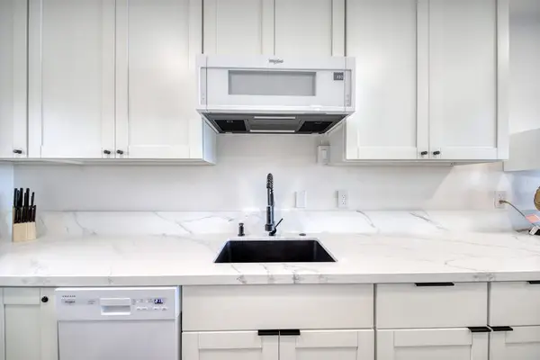Sparkling Clean White Cabinetry And Premium Countertop Finishes