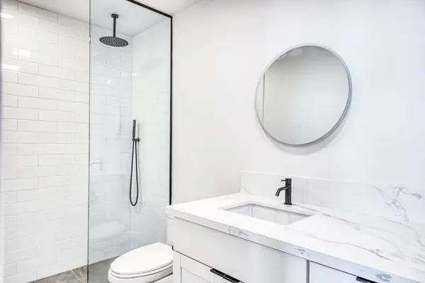 Sleek Round Mirror Accents Complement A Bright Clean Space
