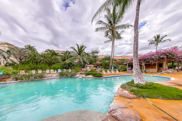 Resort-style pool surrounded by tropical gardens