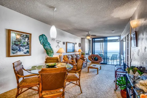 Inviting dining area with a glass-top table and seating, opening up directly into the living room