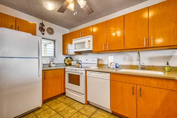 Fully functional kitchen featuring a refrigerator, stove, microwave, dishwasher, and plenty of cabinet storage
