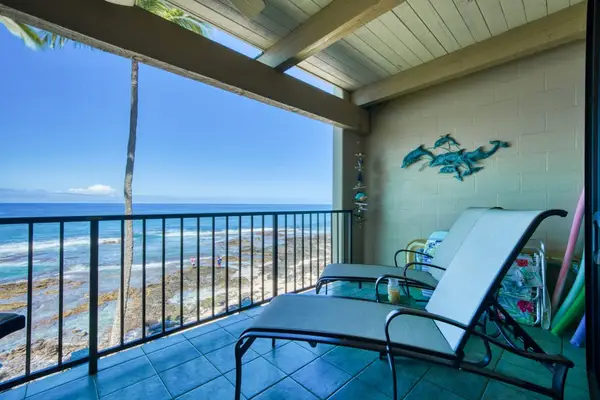 Scenic private balcony featuring comfortable lounge chairs and breathtaking, direct views of the ocean