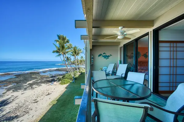 Private covered balcony featuring an outdoor patio table, seating, and incredible oceanfront views