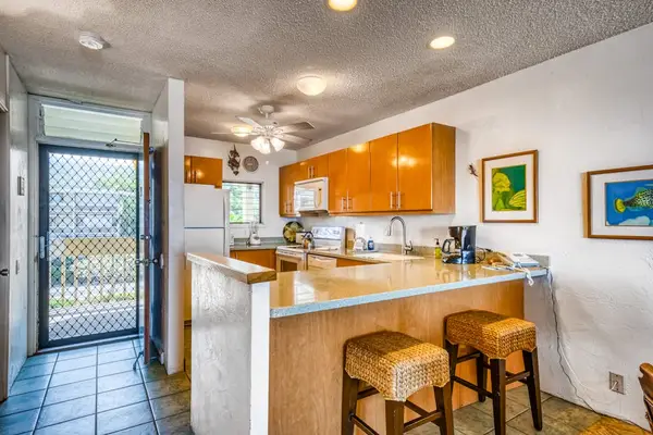 Functional kitchen area featuring a breakfast bar with barstools and plenty of counter space