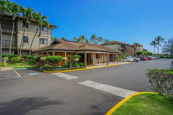 Inviting Community Entrance With Palm Trees