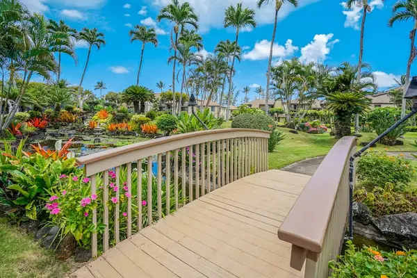 Scenic Garden Bridge Surrounded By Flowers