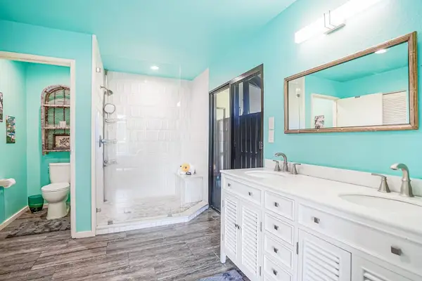 Primary ensuite bathroom with dual vanity and walk-in shower