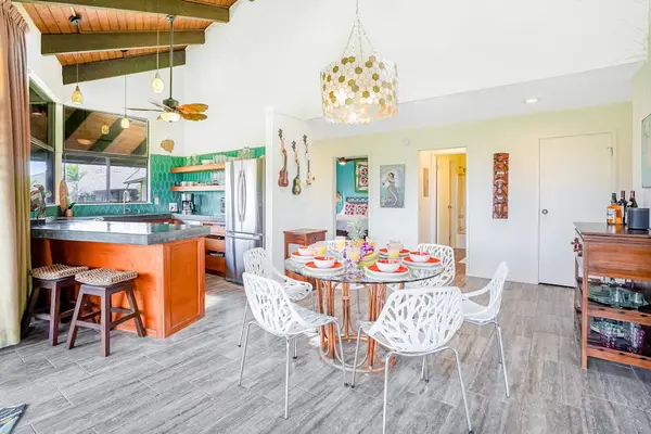 Open-concept dining space flowing into the kitchen and living room