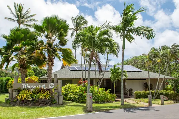 Wavecrest entrance welcomes guests with palms tropical landscaping and signage