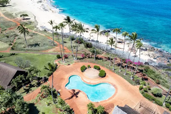 Aerial resort grounds feature lush lawns cottages and Pacific Ocean