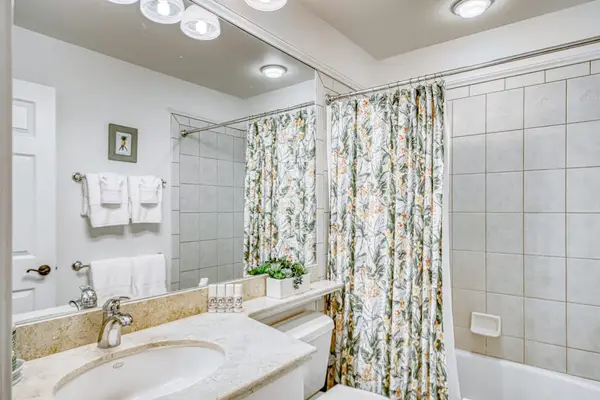 Bright bathroom with a shower and bathtub