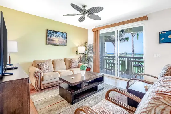 Spacious living room with comfortable seating, flat screen tv and natural light streaming in from the private lanai.