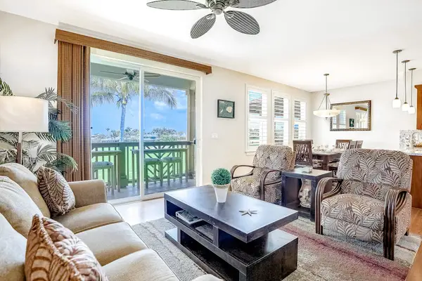 Spacious living room with comfortable seating, flat screen tv and natural light streaming in from the private lanai.