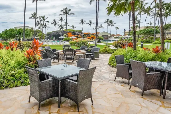 Inviting Courtyard Dining Area Surrounded By Tropical Gardens
