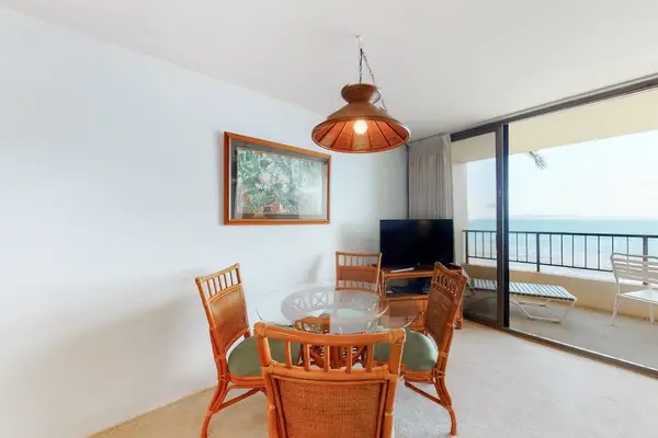 Dining room table with seating for four with views of the ocean through the lanai.