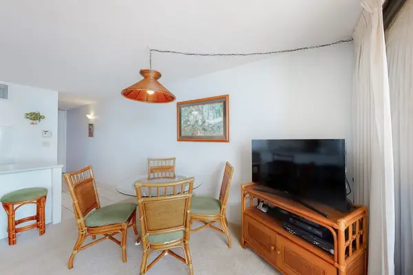 Dining room table with seating for four with views of the ocean through the lanai.
