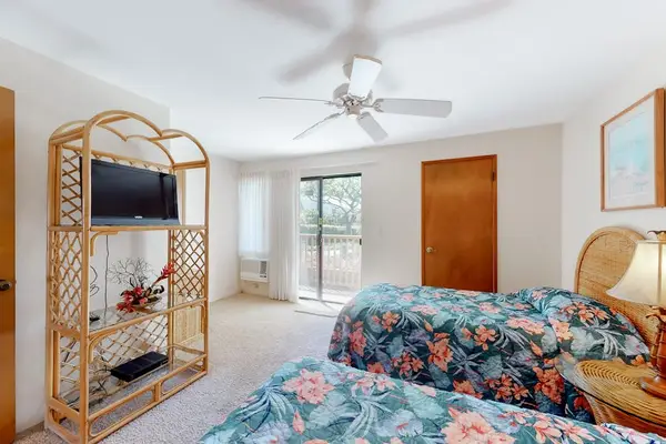 First floor bedroom with rattan accents and lanai access