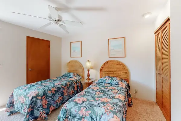 First floor bedroom with twin beds and tropical décor