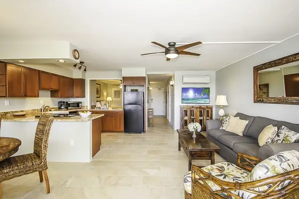 Living room which is open to the dining room and kitchen in this open concept design.