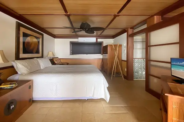 Master bedroom with king bed and flat screen tv.