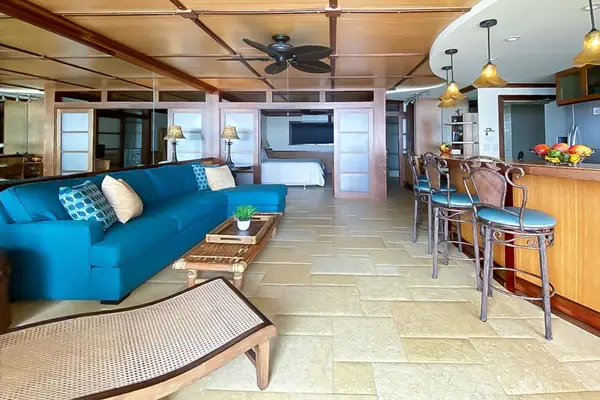 Living room comfortable seating, sofa bed, flat screen tv and views from the lanai.